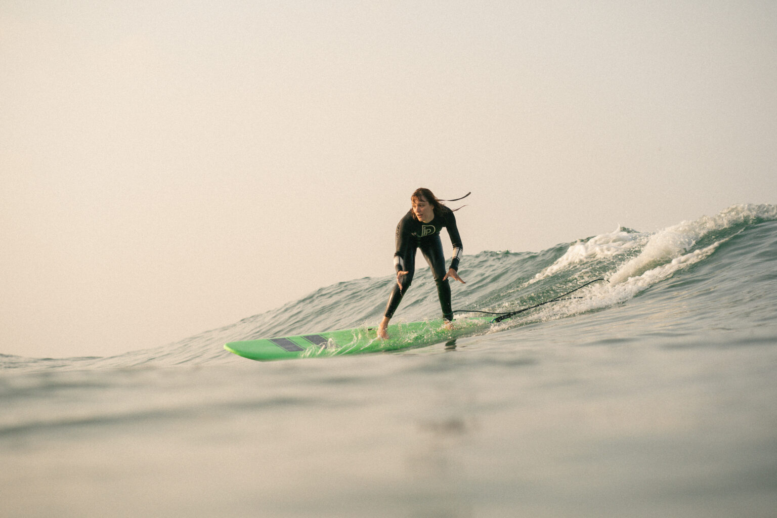 Beginner surfer catching a green wave doing a lesson with the morocco surf camp pack