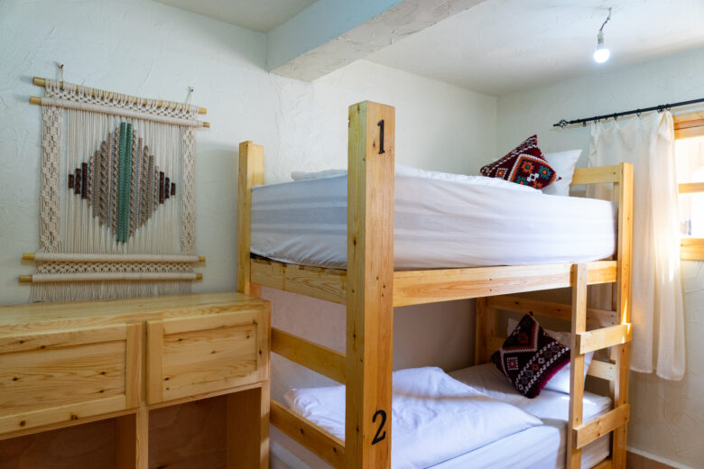 female dorm room at anza surfhouse with macrame decoration